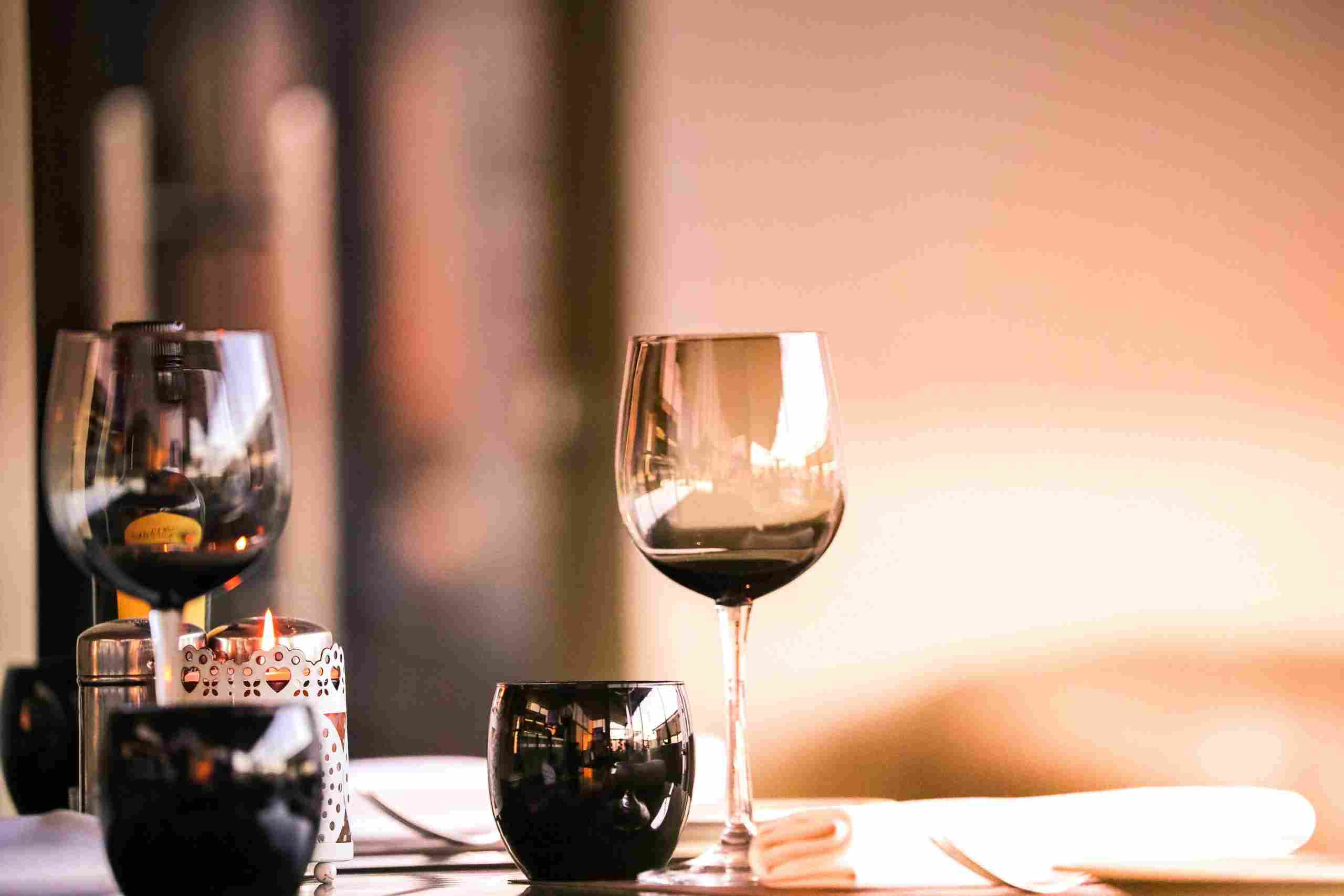 Elegant restaurant dining setting with wine glasses and candlelight, representing Restaurant Kiosk Financing, Restaurant Technology Financing, Restaurant Property Financing, Restaurant Drive Thru Funding, and Restaurant Line of Credit for restaurant owners seeking capital to modernize, expand, and grow their operations.