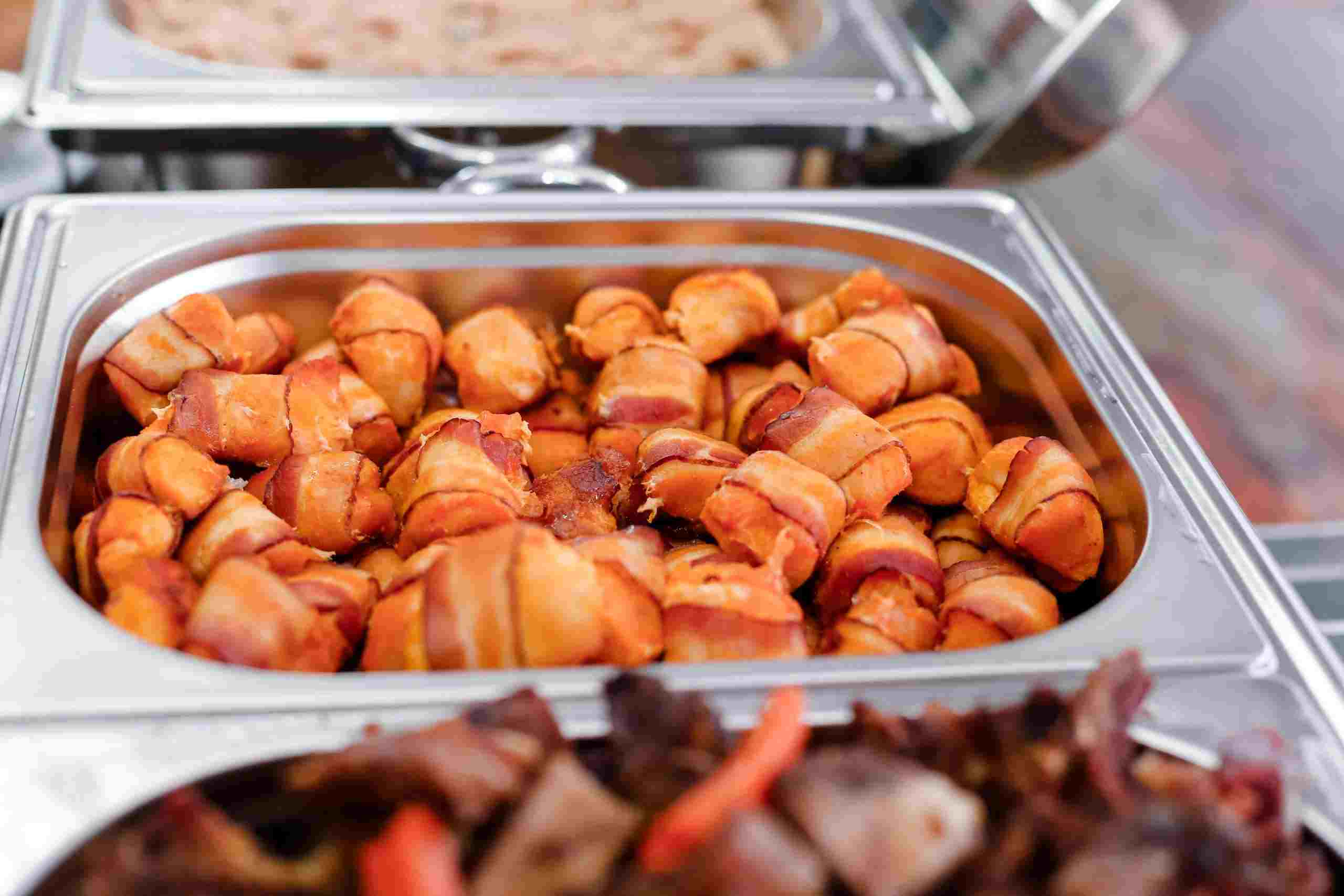 Restaurant buffet and catering food display featuring prepared appetizers and hot food trays, illustrating Restaurant Improvement Loans, Commercial Refrigerator Financing, Restaurant Development Financing, and Restaurant Location Expansion Loans used to support restaurant growth, equipment upgrades, and multi-location expansion.