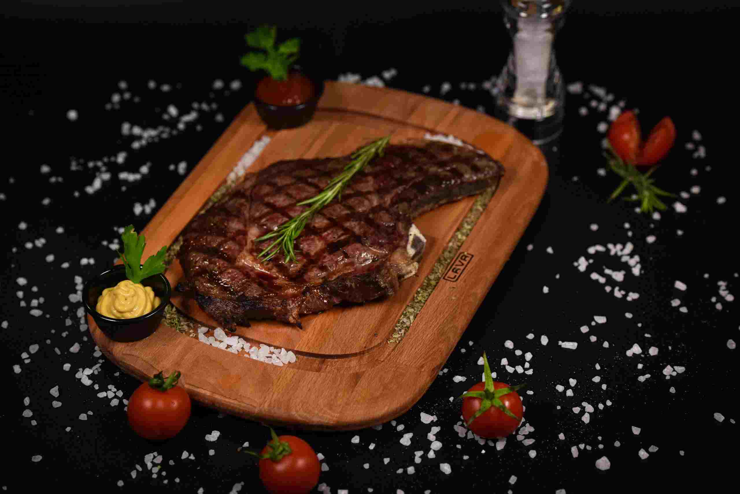 Premium grilled steak served on a wooden presentation board in an upscale restaurant setting, illustrating how businesses may utilize Restaurant growth capital, restaurant business expansion loans, restaurant renovation financing, and restaurant real estate financing to expand locations, modernize facilities, improve dining experiences, and acquire commercial properties.